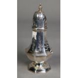 LATE VICTORIAN ENGRAVED SILVER PEDESTAL PEPPERETTE, of panelled form, decorated with foliate