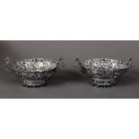 LATE VICTORIAN PAIR OF EMBOSSED AND PIERCED SILVER TWO HANDLED BON BON DISHES, each with dragon’s