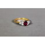 18ct GOLD RING SET IN WHITE GOLD WITH A CENTRAL RUBY FLANKED WITH SIX DIAMONDS, 4.1 gms gross