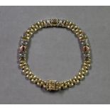 9ct GOLD GATE LINK BRACELET, with three fancy triple link sections, 7 1/2in (19cm) long, 10gms