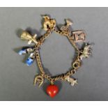 9ct GOLD CURB PATTERN CHARM BRACELET with ring clasp and seven gold Hebrew and other charms, an