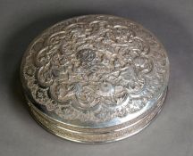 MIDDLE EASTERN EMBOSSED SILVER COLOURED METAL CIRCULAR BOX AND COVER, of shallow form with domed