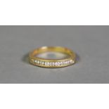 18ct GOLD RING, channel set with a row of nine small round brilliant cut diamonds, 3gms, ring size M