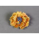 18ct GOLD FLOWER HEAD BROOCH, the centre set with a cluster of six small sapphires, 1 1/8in (2.