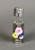 SMALL GLASS CYLINDRICAL PERFUME FLASK with pierced silver overlay and with applied porcelain posy of