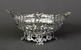 LATE VICTORIAN PIERCED SILVER BON BON DISH BY WILLIAM COMYNS, of elliptical form with shell capped
