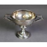 GEORGE V SILVER TWO HANDLED TROPHY CUP, of typical form with angular scroll handles, 3 ½” (8.9cm)