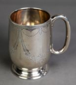 GEORGE VI ENGRAVED SILVER CHRISTENING MUG, of footed form with loop handle, decorated with floral