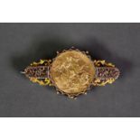 GEORGE V 1911 GOLD FULL SOVEREIGN, loose mounted in a contemporary 9ct GOLD BAR BROOCH, floral