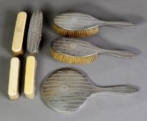 GEORGE V ENGINE TURNED SILVER BACKED FOUR PIECE DRESSING TABLE HAND MIRROR AND BRUSH SET,
