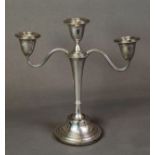 WEIGHTED SILVER THREE LIGHT TWIN BRANCH CANDELABRUM, with tapering column, scroll arms, urn shaped