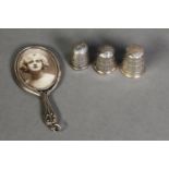 TWO SILVER THIMBLES, A STERLING SILVER THIMBLES AND A SILVER MINIATURE HAND MIRROR PATTERN