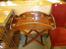 A REPRODUCTION DROP-SIDES BUTLERS TRAY WITH 'X' SHAPED FOLD-AWAY STAND