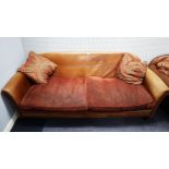 A LARGE TETRAD 'MONTANA GRAND SOFA' COVERED IN BROWN LEATHER WITH LOOSE FABRIC CUSHIONS