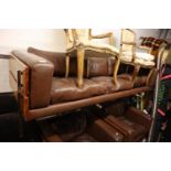EAMES STYLE BROWN LEATHER AND SIMULATED WOOD THREE PIECE LOUNGE SUITE, SUPPORTED ON BOX SECTION
