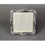 EARLY TWENTIETH CENTURY EMBOSSED SILVER FRONTED DESK TOP PHOTOGRAPH FRAME, apparently unmarked, with