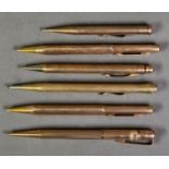 SIX RETRACTABLE PENCILS IN ROLLED OR FILLED GOLD CASES, including three EVERSHARP’ examples, (6)