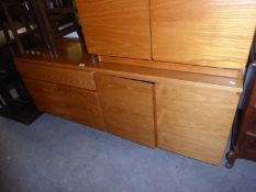 1980’S TEAK SIDEBOARD, HAVING ONE DRAWER OVER TWO CUPBOARDS AND TWO LARGE CUPBOARDS