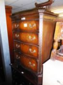A MODERN MAHOGANY SERPENTINE CHEST OF FOUR GRADUATED DRAWERS