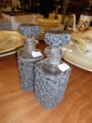 PAIR OF VINTAGE GLASS SQUARE TOILET BOTTLES AND STOPPERS, each with a foliate scroll pierced white