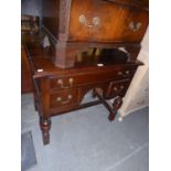 A 1930's JACOBETHAN LOWBOY, HAVING ONE LONG DRAWER ABOVE TWO SMALL DRAWERS