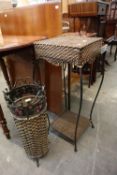 A WICKER AND METAL SQUARE TOPPED JARDINIERE STAND AND A SIMILAR CIRCULAR UMBRELLA/STICK STAND (2)
