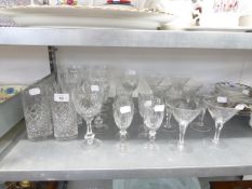 A SET OF 9 CUT GLASS COCKTAIL GLASSES, WHEEL ENGRAVED WITH ROSES, SEVEN CUT GLASS STEM WINE