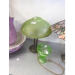 A METAL TABLE LAMP WITH DOMED GREEN FROSTED GLASS SHADE AND A GREEN GLASS PEDESTAL SUGAR BASIN (2)