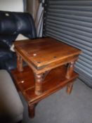 AN INDONESIAN DARK WOOD RECTANGULAR COFFEE TABLE WITH METAL STUDS AND CORNERS AND A MATCHING