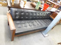 A TEAK FRAMED SETTEE, COVERED IN BLACK BUTTON UPHOLSTERED LEATHER, 7'6" LONG, BY WESTNOFA FURNITURE,