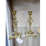PAIR OF LATE NINETEENTH CENTURY CONTINENTAL BRASS AND ENAMELLED COMPOSITION CANDLESTICKS, 7" (