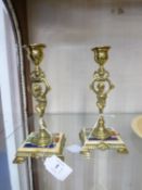 PAIR OF LATE NINETEENTH CENTURY CONTINENTAL BRASS AND ENAMELLED COMPOSITION CANDLESTICKS, 7" (
