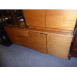 1980’S TEAK SIDEBOARD, HAVING ONE DRAWER OVER TWO CUPBOARDS AND TWO LARGE CUPBOARDS