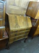 A WALNUT WOOD BUREAU WITH SLOPING FALL FRONT, THREE LONG DRAWERS BELOW, ON CABRIOLE LEGS WITH CLAW