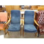 A PAIR OF MID-CENTURY TEAK FRAMED FIRESIDE ARMCHAIRS, WITH SWEPT ARMS, TAPERING LEGS, BY FRANCE