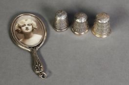TWO SILVER THIMBLES, A STERLING SILVER THIMBLES AND A SILVER MINIATURE HAND MIRROR PATTERN