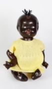 COMPOSITION BLACK BABY DOLL with five-part body, the head with moulded hair and wool top-knot,