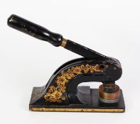 EARLY TWENTIETH CENTURY JAPANNED STEEL GILT EMBELLISHED DESK PUNCH