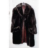 LADY'S BLACK THREE-QUARTER LENGTH FUR COAT with short revered collar, single breasted hook fastening