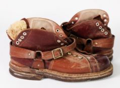 PAIR DAOUST VINTAGE LEATHER SKI BOOTS with laceholes to the front and heel and leather straps, heavy