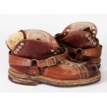 PAIR DAOUST VINTAGE LEATHER SKI BOOTS with laceholes to the front and heel and leather straps, heavy