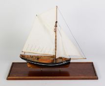 PAINTED WOOD MODEL OF THE SCILLY ISLES FISHING BOAT AGNES, under full sail, with solid wooden