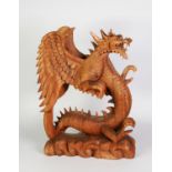 LARGE SOUTH-EAST ASIAN WOOD CARVING OF A REARING WINGED DRAGON, on cloud carved base, 19 ½” (49.5