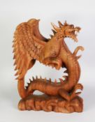 LARGE SOUTH-EAST ASIAN WOOD CARVING OF A REARING WINGED DRAGON, on cloud carved base, 19 ½” (49.5