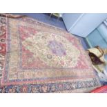 KIRMAN, PERSIAN CARPET with circular and petal shaped sky blue centre medallion with pendants, on an