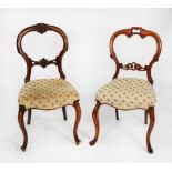 TWO SIMILAR PAIRS OF VICTORIAN CARVED WALNUT DINING CHAIRS, each with waisted back, serpentine