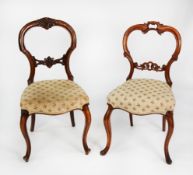 TWO SIMILAR PAIRS OF VICTORIAN CARVED WALNUT DINING CHAIRS, each with waisted back, serpentine