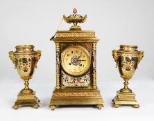 CIRCA 1900 FRENCH GILDED BRASS AND CHAMPLEVE ENAMEL CLOCK GARNITURE, the movement striking on a