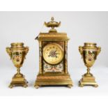 CIRCA 1900 FRENCH GILDED BRASS AND CHAMPLEVE ENAMEL CLOCK GARNITURE, the movement striking on a