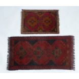 AFGHAN KHAN HAND-WOVEN PURE WOOL RUG, crimson and black with a row of three quatrefoil medallions,